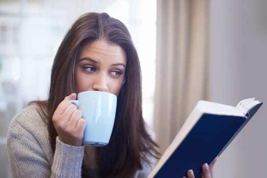 Woman, drinking coffee and reading book for knowledge at home, literature and fiction novel for relaxation. Female person, tea and information for learning, comfortable and fantasy story on weekend