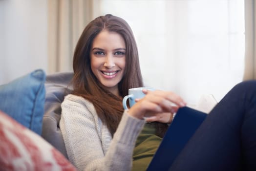 Woman, drinking coffee and reading book to relax in portrait, literature and fiction novel for knowledge. Female person, happy and information for learning, comfortable and story on weekend at home