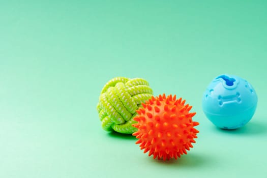 Pet toys on green background close up