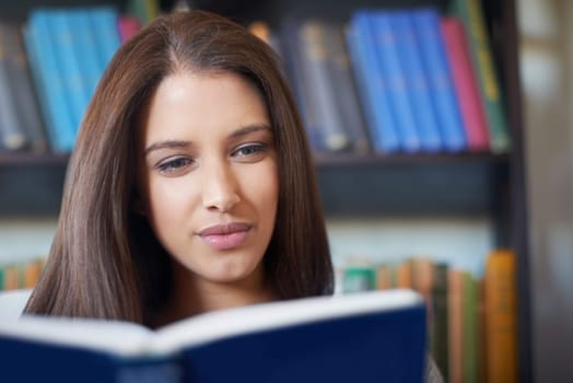 Face of woman, library or reading book for studying knowledge, literature and fiction novel to relax. Female person, student and information for learning, education and fantasy story in university