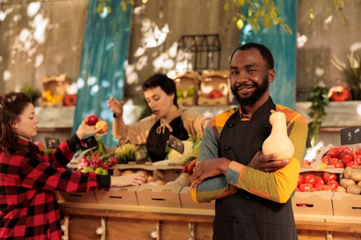 Happy african american vendor preparing to sell organic food