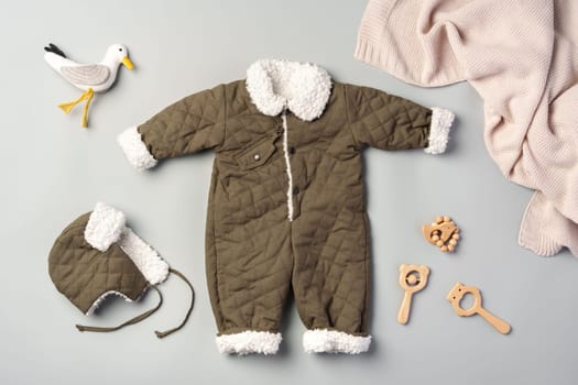 Gray quilted baby overalls for winter flat lay