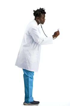 The doctor, in full height, on a white background, uses a stethoscope
