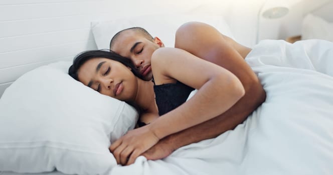 Couple, hugging and sleeping in bed together, love and resting or comfortable at home on weekend. People, bedroom and security in embrace, bonding and nap on sunday morning and relaxing or dreaming
