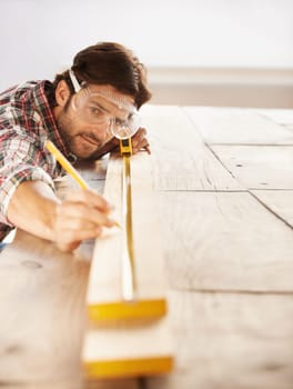 Man, wood and carpenter with idea, planning and building for home improvement, remodeling and renovation. Handyman, craftsman and contractor with maintenance, wood and skill for measurement or repair