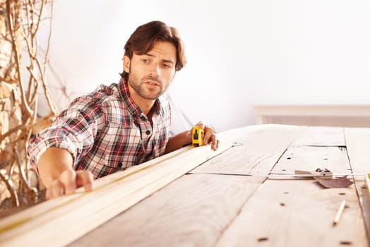Man, carpenter and wood with craft, home and tools for work, building and maintenance. Handyman, workbench and diy or craftsmen, contractor and artisan with face, thinking or planning for improvement