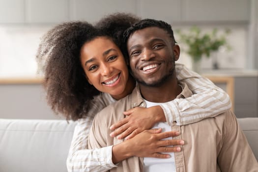 Joyful Black Wife Hugging Husband From Back At Home