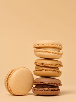Stack of chocolate macarons on beige background