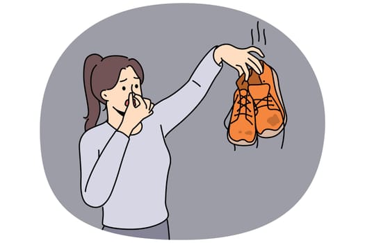 Woman cover nose disgusted with smelly shoes