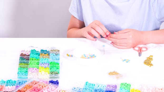 Little Girl’s Adventure in Bracelet Making with a Rainbow of Beads