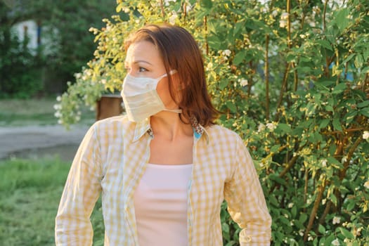 Mature woman in protective medical mask, female outdoor