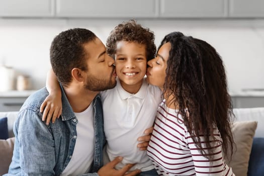Happy Family Portrait. Closeup Of Loving Black Parents Kissing Their Preteen Son