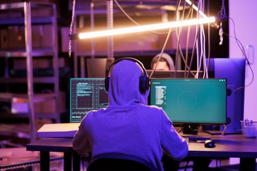 Hacker in headphones breaching data