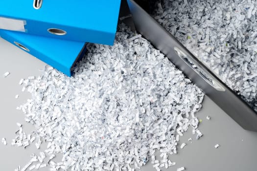 Paper folder and shredded paper in office