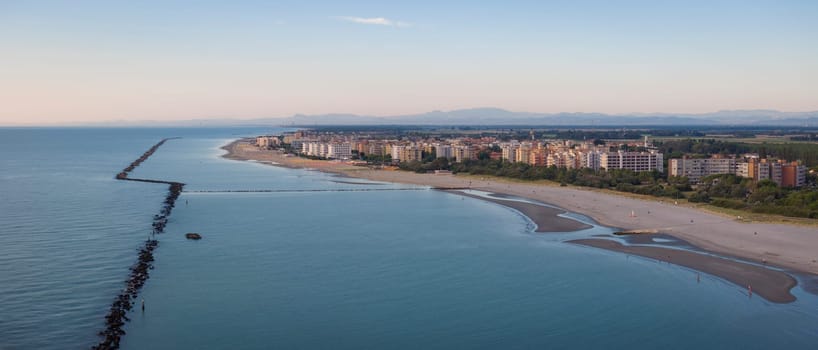 Drone view of sandy beach and Adriatic sea.Summer vacation concept.Lido Adriano town,Adriatic shore, Emilia Romagna,Italy.