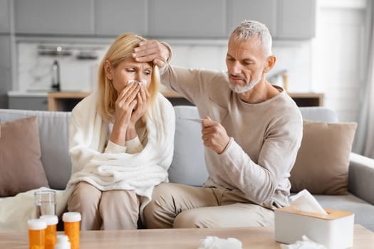 Senior man treating his sick wife at home