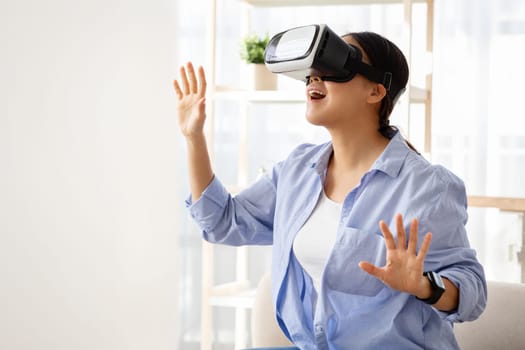 Young asian woman in VR headset have fun at home