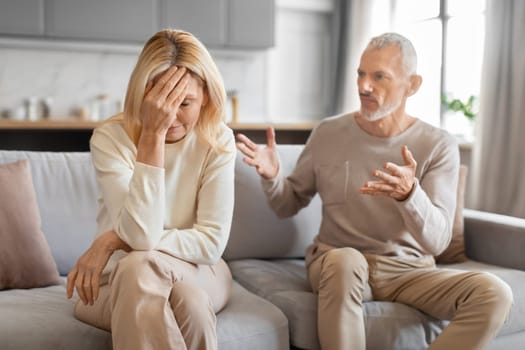 Angry elderly man yelling at his tired upset wife