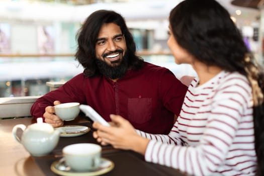 Beautiful young indian couple have romantic date at cafe