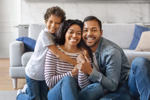 Happy Loving Family. Cheerful African American parents and son posing for photo at home