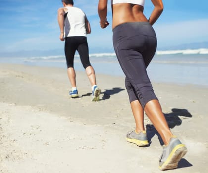 Running, beach and man with woman, fitness and cardio with workout and training for wellness. Healthy, runner and athlete with practice and vacation with water and waves with sunshine or getaway trip