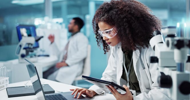 Laptop, woman or scientist in laboratory with tablet or research for chemistry report or medical test. Doctor, person typing or science update for online medicine development or virus news on website
