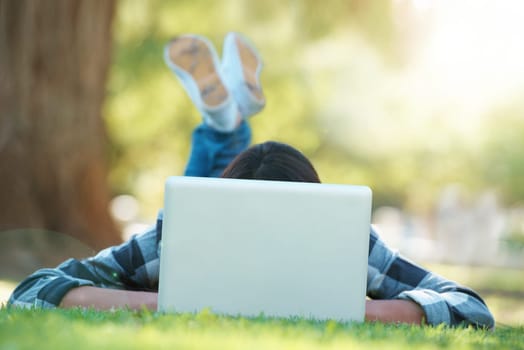 Laptop, lawn or woman in park for elearning with knowledge, information or education. Nature, university learner or female student on grass for studying history or typing online on college campus