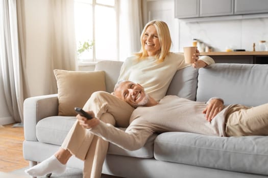 Relaxed elderly couple enjoying weekend together at home