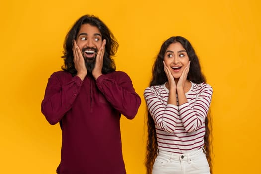 Surprised millennial indian man and woman gesturing