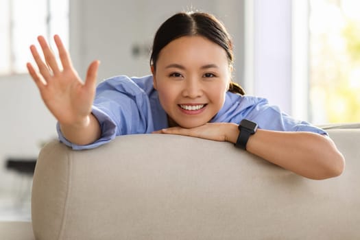Cheerful asian woman showing high five gesture