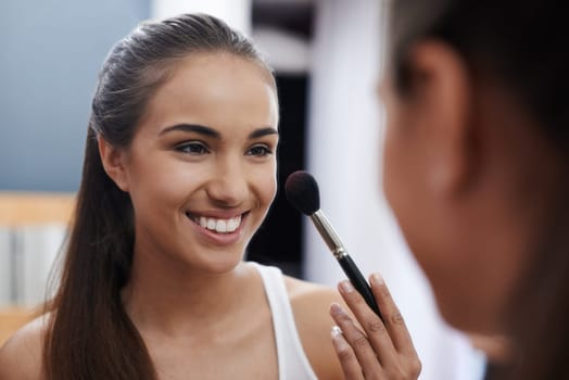 Women, makeup and mirror in bedroom, smile and blush for beauty. Female, brush and wellness connect for home, relaxation and beauty talk for happiness, skincare and antioxidant treatment for date