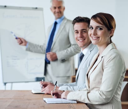 Portrait or business people or boss teaching in a meeting for presentation, coaching or team training. Smile, man or woman in boardroom meeting for skills, group learning or education in a mentorship