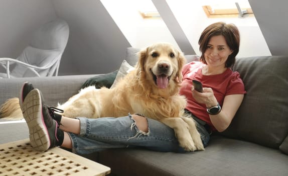 Girl with golden retriever dog at home