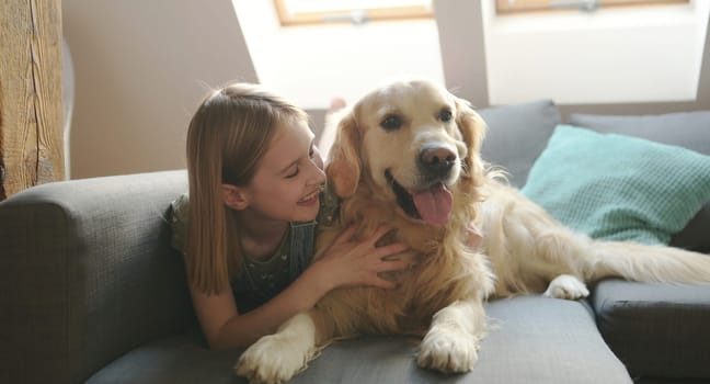 Girl with golden retriever dog at home