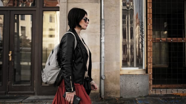 Stylish Woman With Sunglasses Strolls Down City Street