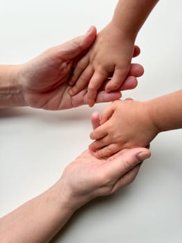Womans gesture with child's hand on white surface