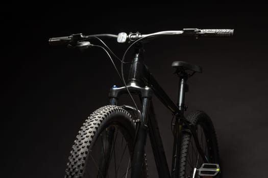 Black mountain bicycle on black background