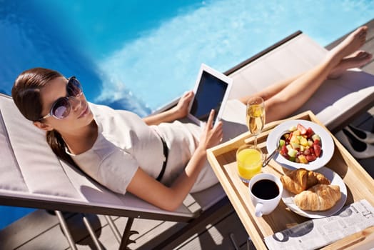 Hotel, pool and woman with breakfast, tablet and relax on business trip for food or drink service. Travel, hospitality and businesswoman on lounge chair at brunch with summer, luxury or villa holiday