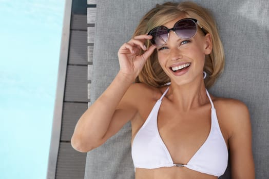 Portrait, swimming pool and woman with smile, sunglasses and vacation with happiness and relaxing on weekend break. Face, person or girl with eyewear or water with summer or holiday with getaway trip
