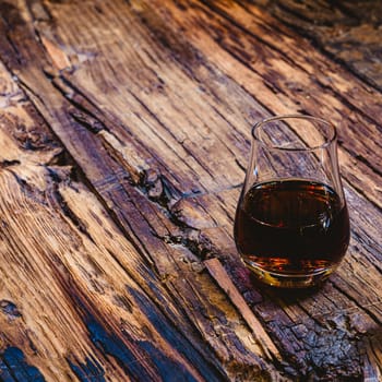 Close Up of a Glass of Sweet Madeira Fortified Wine on wooden table.