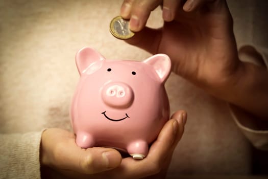 Girl preserve savings with piggy bank.