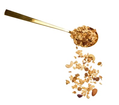 Oatmeal, raisins, cashews and almonds. Granola in metal spoon