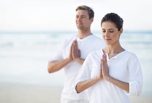 Couple, yoga and ocean with meditation, zen and waves on sand in morning with mindfulness in summer. Man, woman and outdoor for namaste with spiritual growth, balance or peace at beach in Cape Town