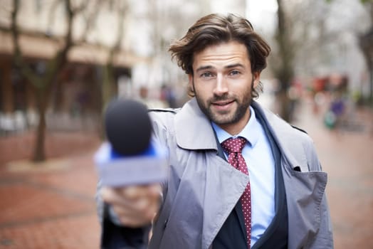 Microphone, city and interview with man, reporting and live streaming with broadcast and journalism. Portrait, person and employee with questions and feedback with breaking news and mic with opinion