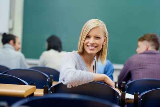 University student, portrait and education at classroom desk in London for english lecture, knowledge or scholarship. Female person, face and academy for certificate or diploma, teaching or lesson