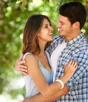 Man, woman and happy with hug in forest for bonding, connection and love in Canada. Couple, smile and summer on date with romantic embrace for admiration, care and affection with bokeh background