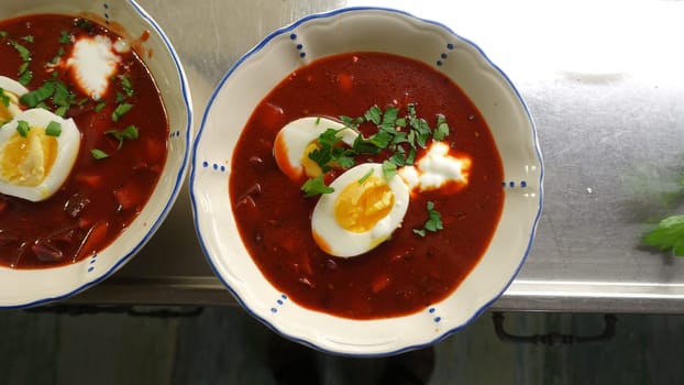 Homemade soup with tomatoes, beetroot, cream eggs and parsley.