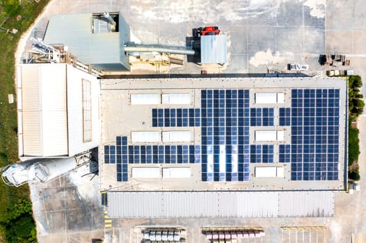 solar panels on the roof of a industrial building. Aerial view from drone 