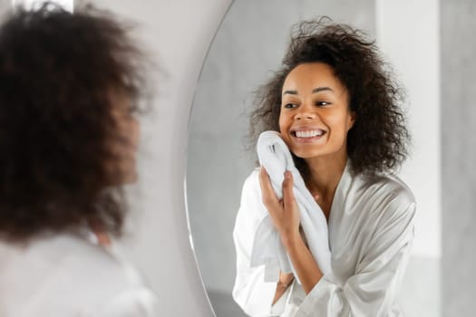 Black Lady Drying Clean Face With Soft Towel In Bathroom