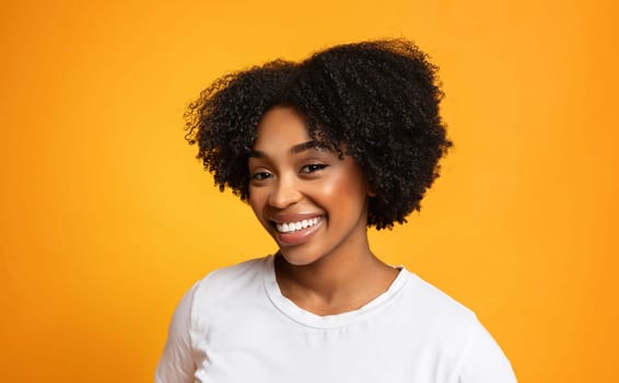 Portrait of cheerful pretty young african american woman on background